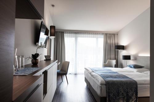 Postel nebo postele na pokoji v ubytování Nuhr Medical - Hotel & Restaurant - Ab 3 Nächtigungen von 04 Dezember 2025 bis 08 Dezember 2025 kostenlose 20 Minuten Massage-Halbpension inkludiert Minus 20 Prozent auf Kosmetikbehandlungen