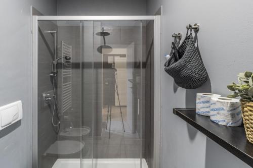 um chuveiro com uma porta de vidro na casa de banho em MilanRentals - Tarra Apartment em Milão
