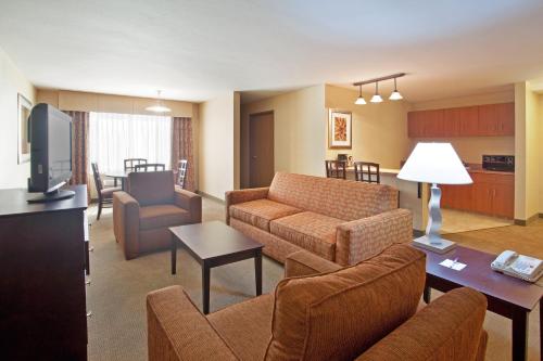 a living room with a couch and a tv at Holiday Inn Express Hotel & Suites Nogales by IHG in Nogales