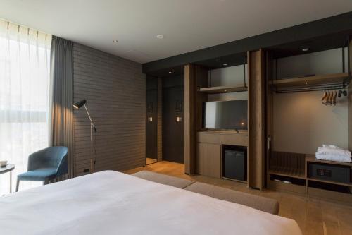 Postel nebo postele na pokoji v ubytování HOTEL CANATA KYOTO