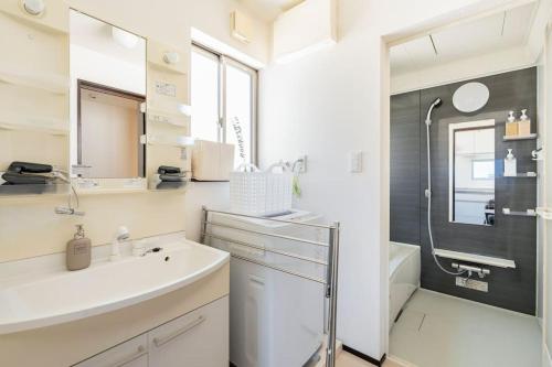 a bathroom with a sink and a shower at FUJIMI TOWN HOUSE in Tokyo