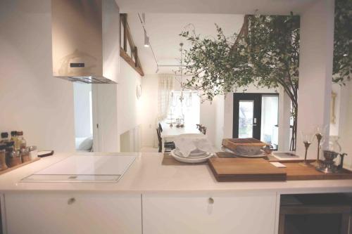 a kitchen with a white counter top with a table at Gonae Reborn in Jeju