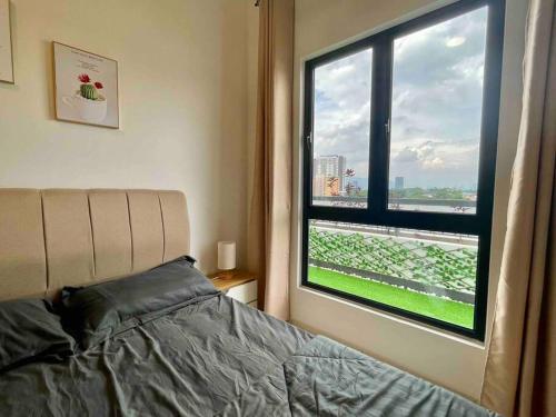 a bedroom with a bed and a large window at The Horizon @ Ipoh - Cozy Condo with Balcony Patio in Ipoh