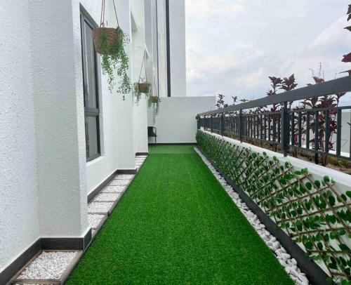 a balcony with green grass on the side of a building at The Horizon @ Ipoh - Cozy Condo with Balcony Patio in Ipoh