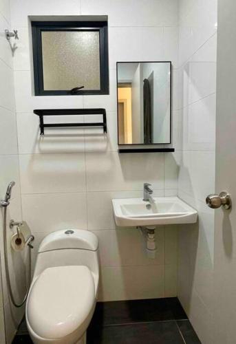 a bathroom with a toilet and a sink at The Horizon @ Ipoh - Cozy Condo with Balcony Patio in Ipoh