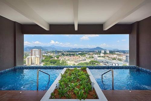 a large swimming pool with a view of a city at The Horizon @ Ipoh - Cozy Condo with Balcony Patio in Ipoh