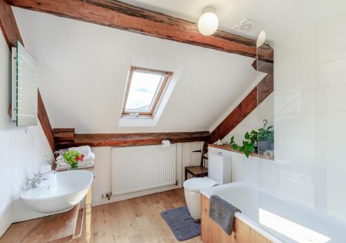 a bathroom with a sink and a toilet and a tub at The Loft in Rhayader