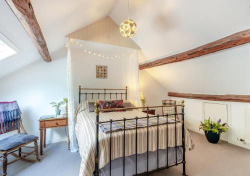 a bedroom with a canopy bed in a attic at The Loft in Rhayader