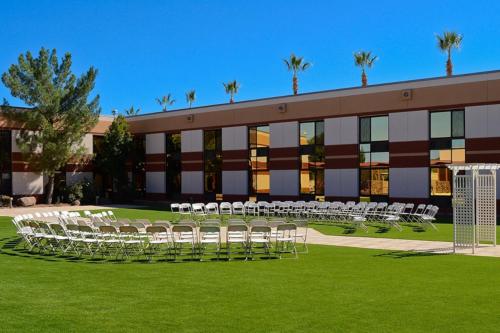 a large building with white chairs in front of it at Apache Gold Resort Hotel & Casino in Globe