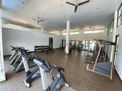 a gym with several treadmills and exercise bikes at Monde Residence I no 6 Batam Centre in Sengkuang