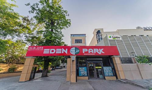 a store with a red sign in front of a building at Treebo Eden Park Hotel, 3 Km From Puducherry Airport in Puducherry