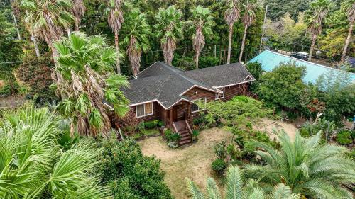 an aerial view of a house with a swimming pool at Valley Village in Seogwipo