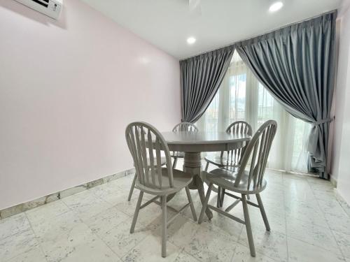 a dining room with a table and two chairs at Century Suria Aparment Langkawi by Zervin in Kuah