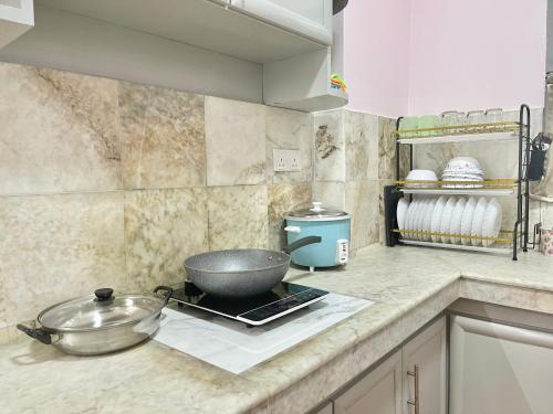a kitchen counter with a bowl on a stove at Century Suria Aparment Langkawi by Zervin in Kuah