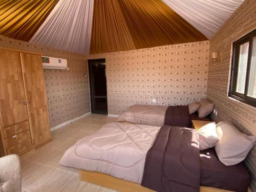 a bedroom with two beds in a room at Desert Moon Camp in Wadi Rum