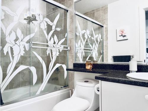 a bathroom with a shower and a toilet and a sink at Charming 1BR near Metrotown DT Burnaby/ Vancouver in Vancouver