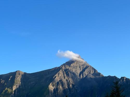 a mountain with smoke coming out of it at Haus Maran in Urmein