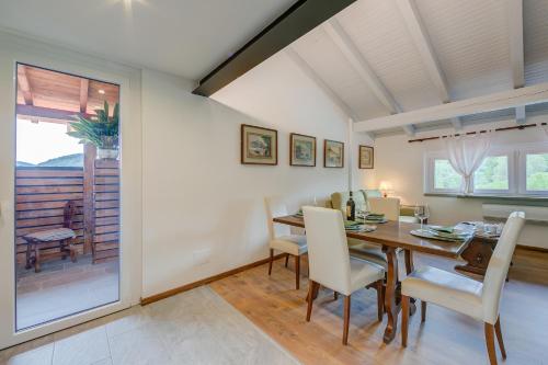 a dining room with a table and chairs at Residenza La Lanterna Pool and Relax - Happy Rentals in Gignese
