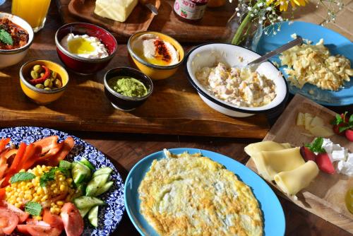 a table with plates of food and bowls of food at MARRAKECH פלא - PELEH - Queit place 3 km from the beach of Cesarea in Or ‘Aqīvāh