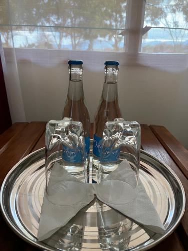 two bottles of soda on a glass plate on a table at Lake Jipe Eco Lodge in Tsavo West National Park