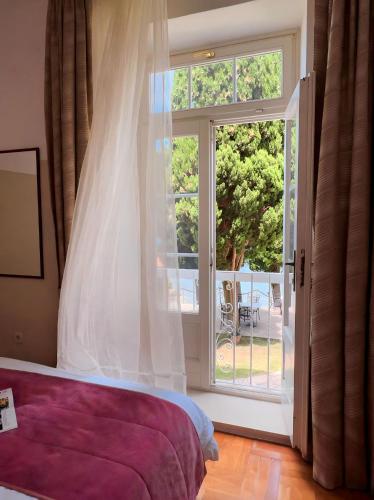 a bedroom with a bed and a large window at Villa Valdepian Apartments in Savudrija