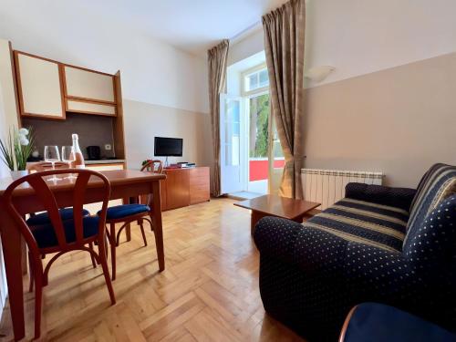 a living room with a table and a couch at Villa Valdepian Apartments in Savudrija