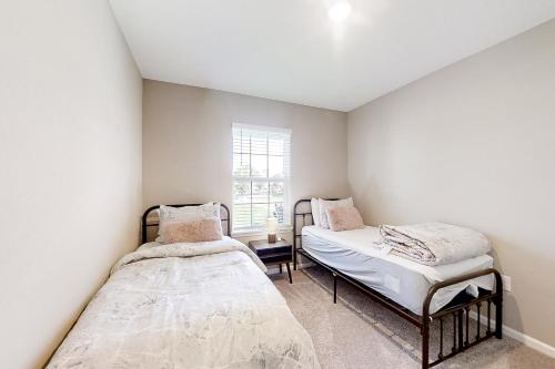 a bedroom with two beds and a window at The Port of Paradise in Port Orange