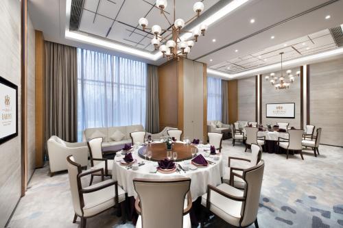 a conference room with a table and chairs at Grand Barony Qingdao Airport Hotel in Qingdao