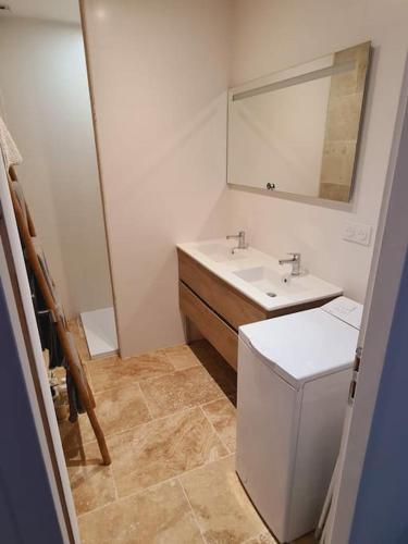 une salle de bain avec un lavabo et un miroir dans l'établissement T3 avec jacuzzi privé exterieur, à Ceyreste