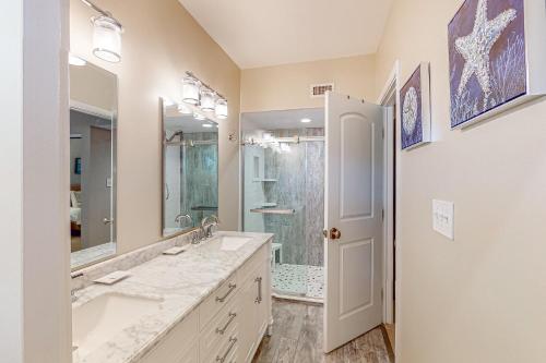 a bathroom with two sinks and a large mirror at Anchorage 7421 in Hilton Head Island