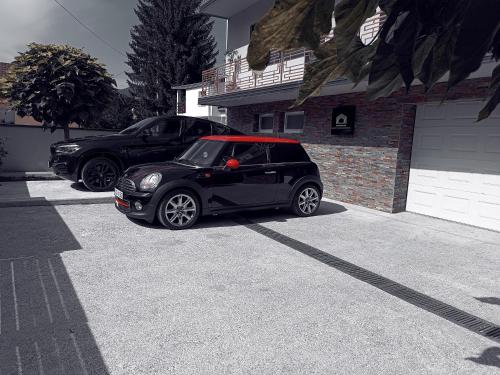 a black car parked in front of a house at Apartments Jack in Bihać