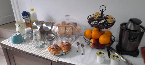 a counter top with bread and fruit on it at I Cappuccini B&B in Sorso