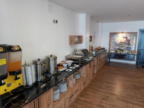 a kitchen with a long counter with pots and pans at The Marine Hotel in Trabzon