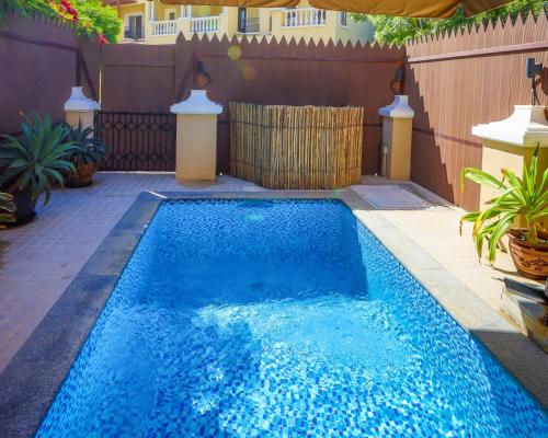 una pequeña piscina azul en el patio trasero en Dar 66 Plunge Pool Resort Townhouses en Ras al-Khaimah