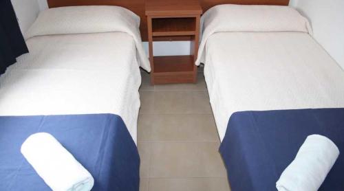 two beds sitting next to each other in a room at Residencia Sant Jordi Llança in Llança