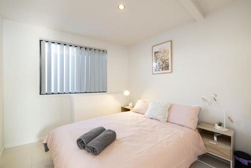 a bedroom with a bed with two pillows on it at 2 Bedroom! Great Location & Walk to Train in Brisbane