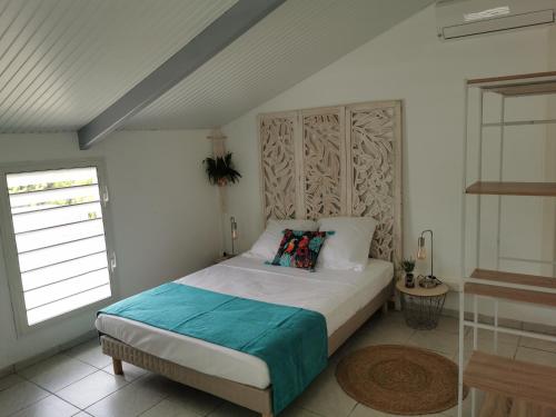 a bedroom with a bed and a window at Résidence La Cafeiere in Saint-Claude