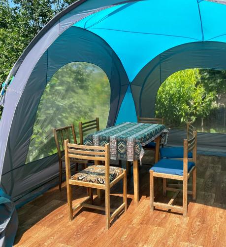 a table and two chairs and a tent at Tereza glamping in Sanain