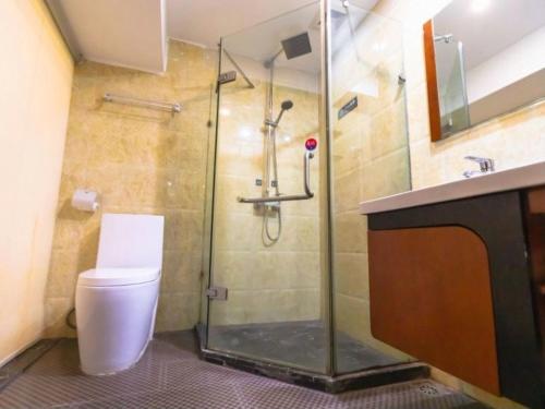 a bathroom with a shower and a toilet and a sink at 7 Days Inn Foshan Lecong Furniture Branch in Shunde
