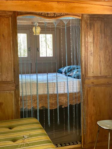 a bed in a cage in a room at Les roulottes de Bayama - logement insolite avec jacuzzi in Mougins
