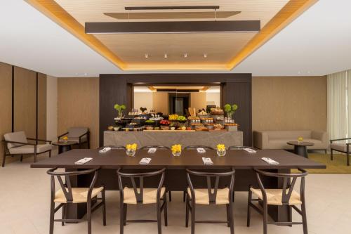 a conference room with a table and chairs at Avani Plus Palm View Dubai Hotel & Suites in Dubai