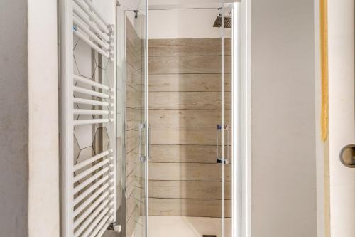 a shower with a glass door in a bathroom at Costaguti 36 Apartment in Rome