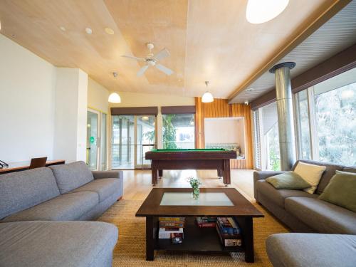 a living room with a couch and a pool table at YHA Apollo Bay Eco in Apollo Bay