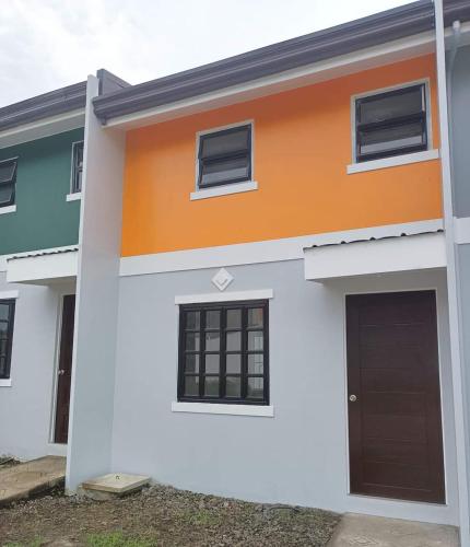 an orange and white house with a garage at IRIGA CITY TRANSIENT HOUSE in Iriga City