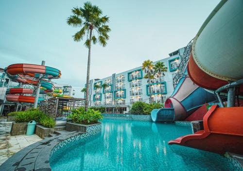 a swimming pool with a water slide and a water park at Astara Hotel Balikpapan in Balikpapan