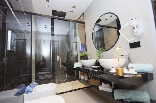 a bathroom with two sinks and a shower at Relais Dea Degli Ulivi in Agrigento