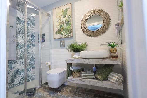 a bathroom with a toilet and a mirror at Relais Dea Degli Ulivi in Agrigento