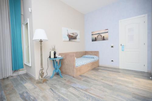 a bedroom with a bed and a table and a lamp at Relais Dea Degli Ulivi in Agrigento