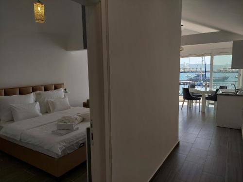 a bedroom with a bed and a dining room with a table at Opera apartments in Tivat