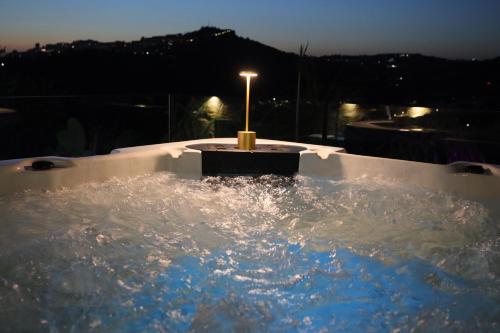 a jacuzzi tub with a candle in it at night at Relais Dea Degli Ulivi in Agrigento